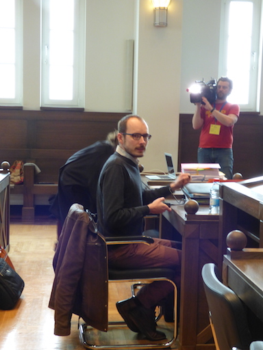 Antoine, sitting at the defense desk