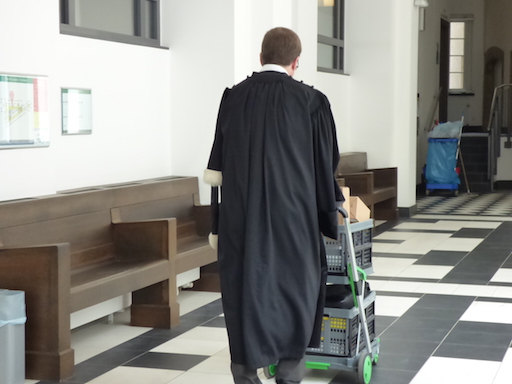 The deputy State attorney David Lentz, pushing a trolley containing the investigation files.